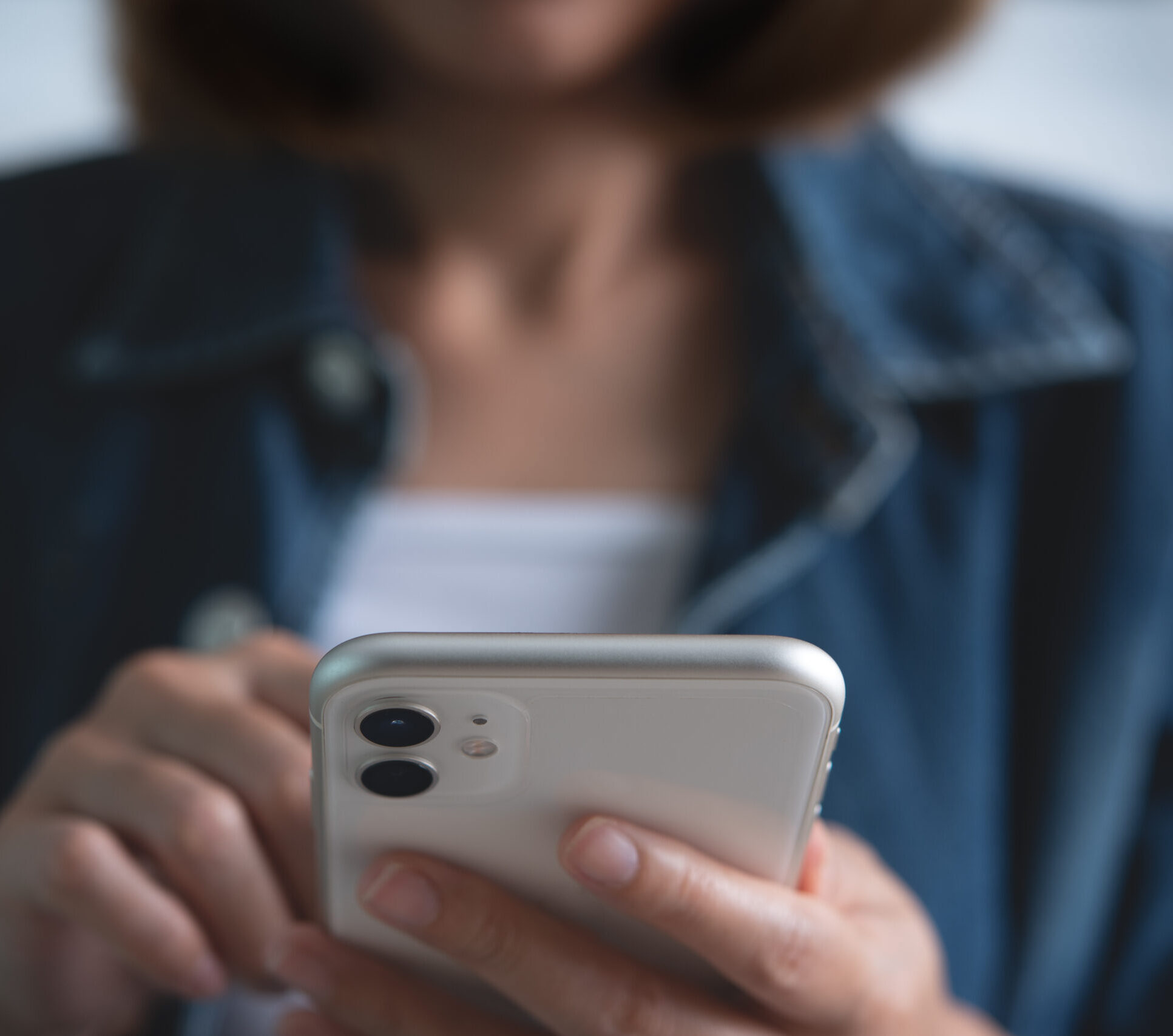 Close up of young asian woman hands holding and using mobile smart phone for online shopping and internet banking via mobile app